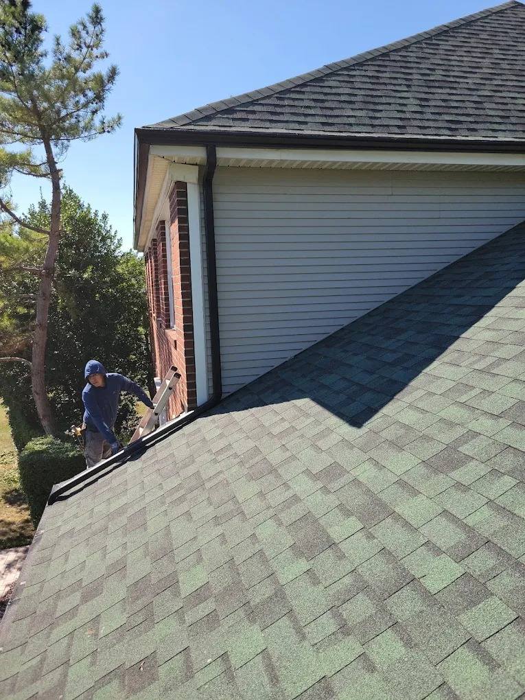 Crew member installing shingles on an Essex County roof