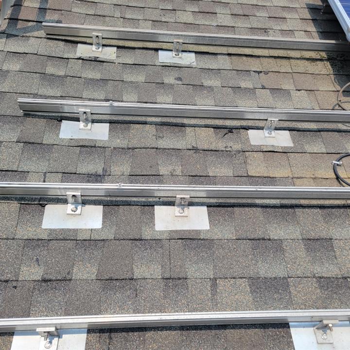 Solar mounting rails and flashing on a shingle roof during a panel detach and reset