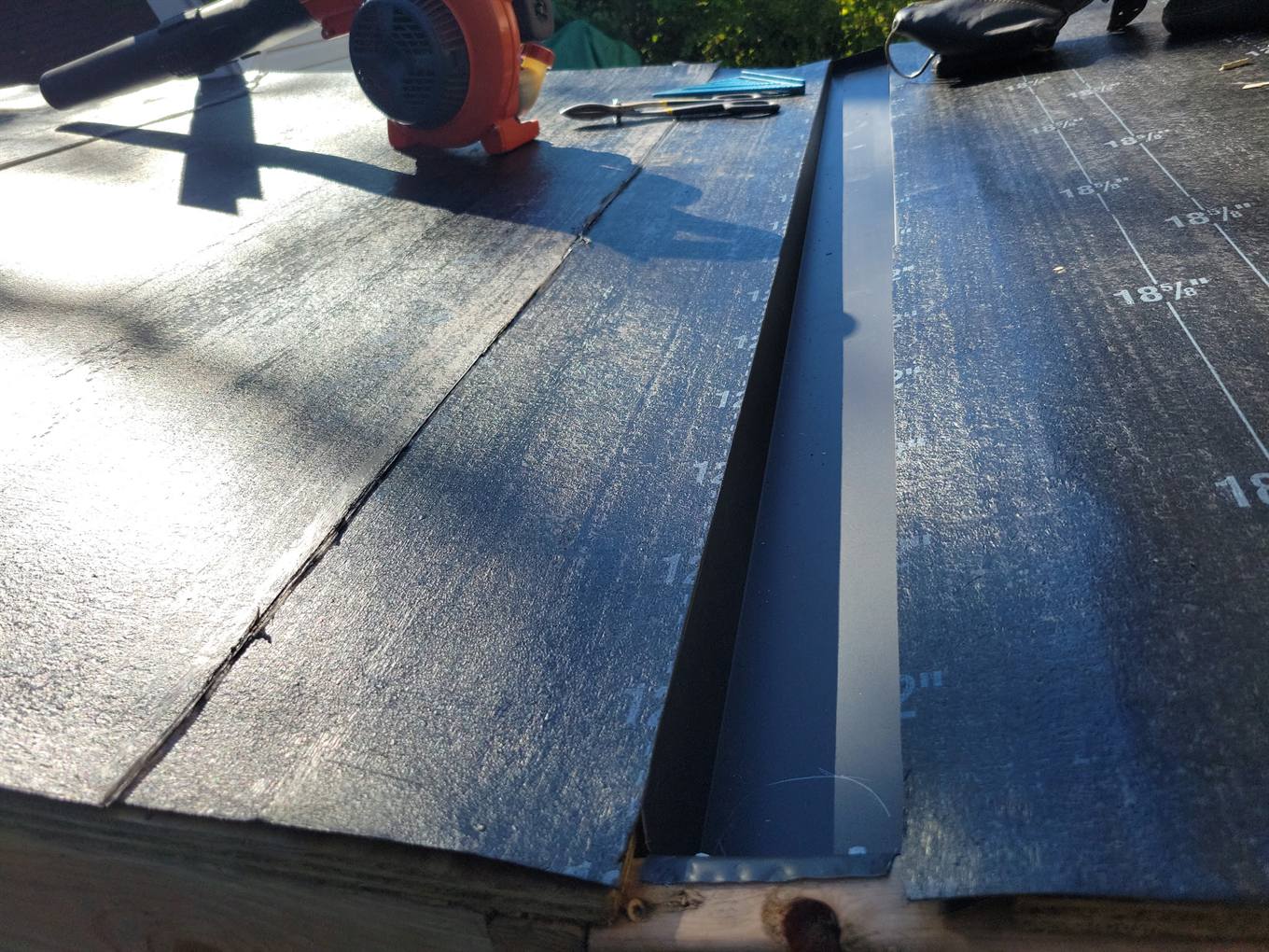 New metal valley flashing and underlayment during a roof replacement
